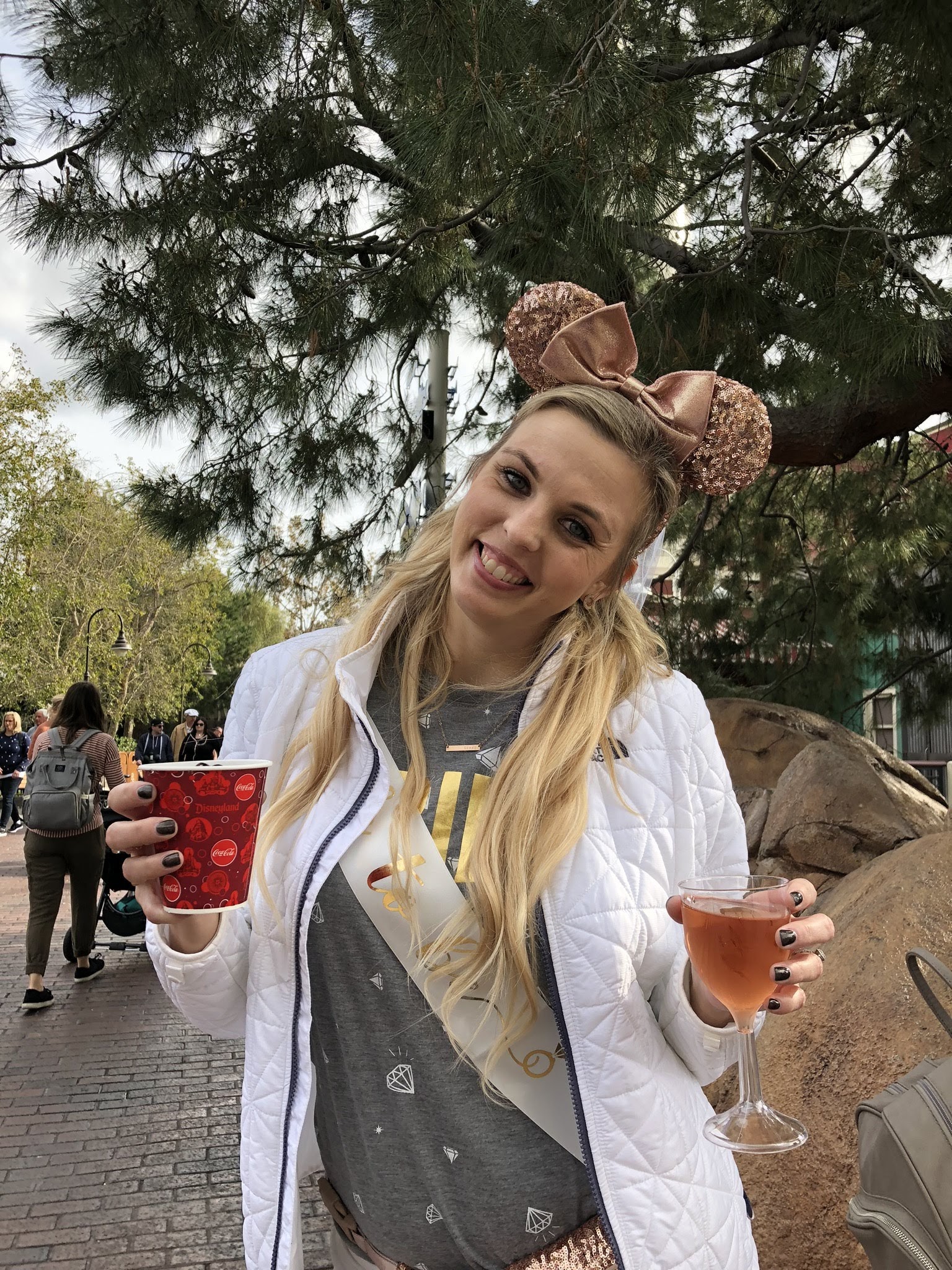 Liesl in Disneyland with coffee and champagne.